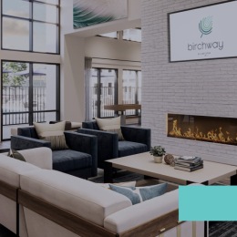 lounge with seating tables tv and large windows