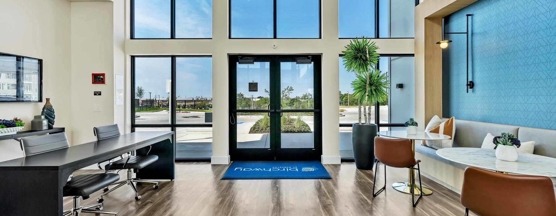 a room with a table chairs and a tv