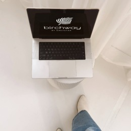 a persons feet and a laptop