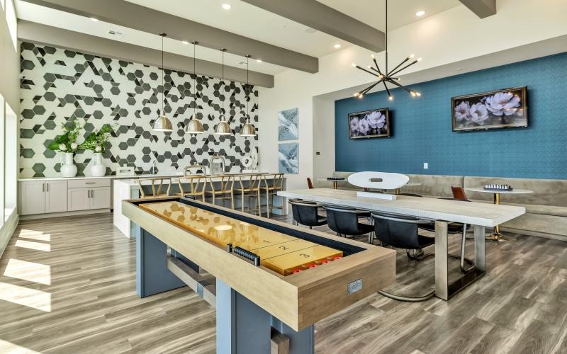 a kitchen with a bar and chairs